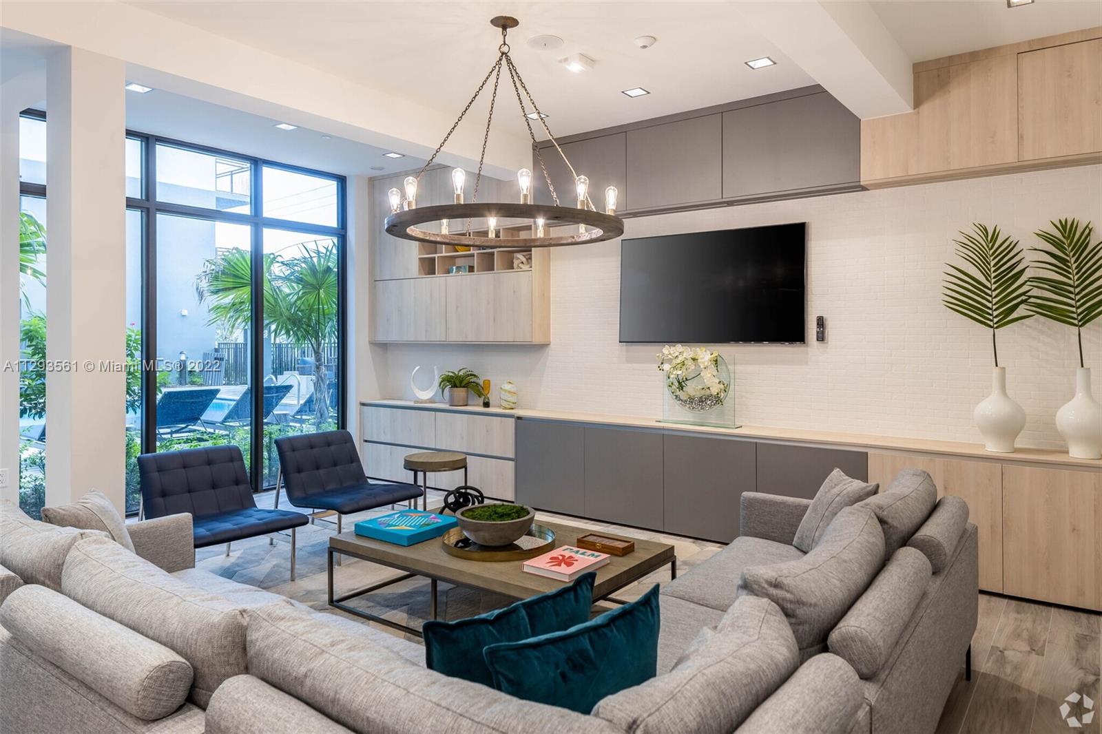 401 Hialeah Drive, Unit 320 Hialeah, FL 33010 - Photo 11 of 27 a living room with furniture a flat screen tv and a large window