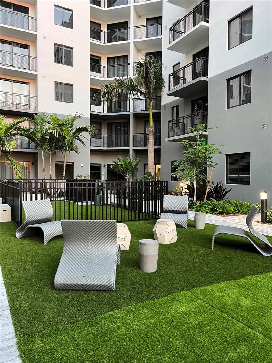 401 Hialeah Drive, Unit 320 Hialeah, FL 33010 - Photo 12 of 27 a view of a patio with plants and chairs