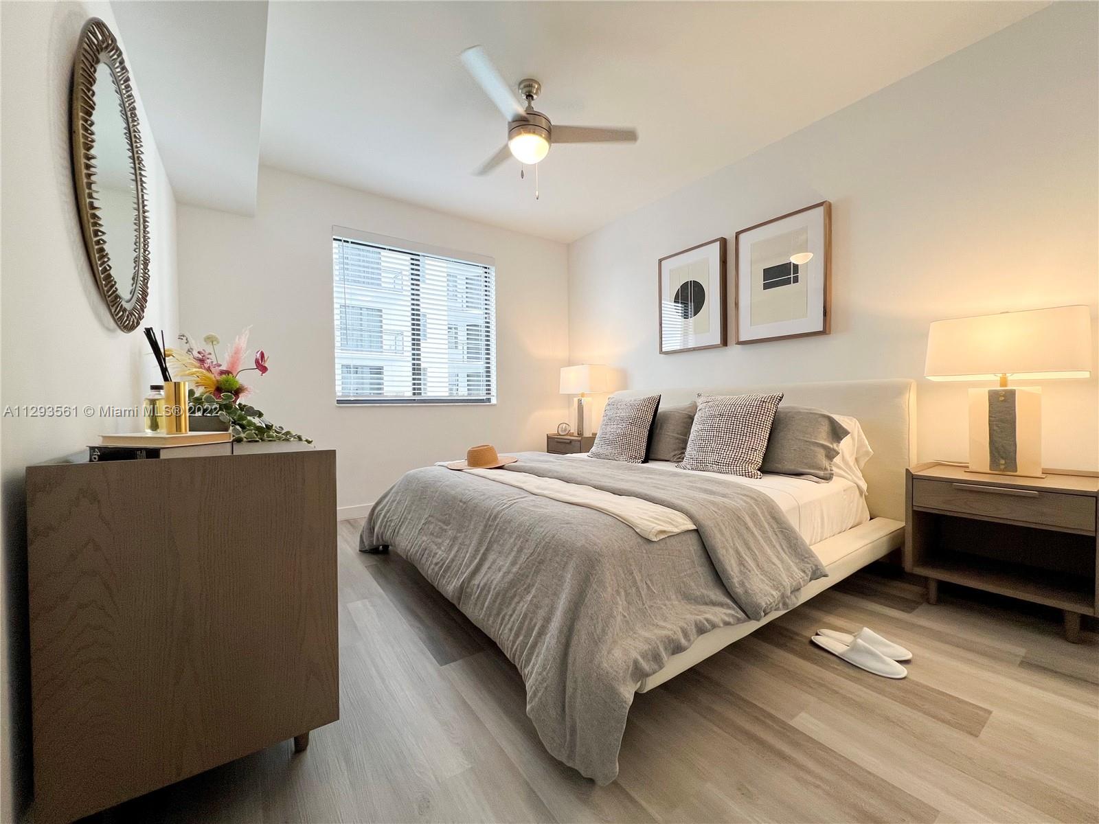 401 Hialeah Drive, Unit 320 Hialeah, FL 33010 - Photo 3 of 27 a bedroom with bed and a large mirror