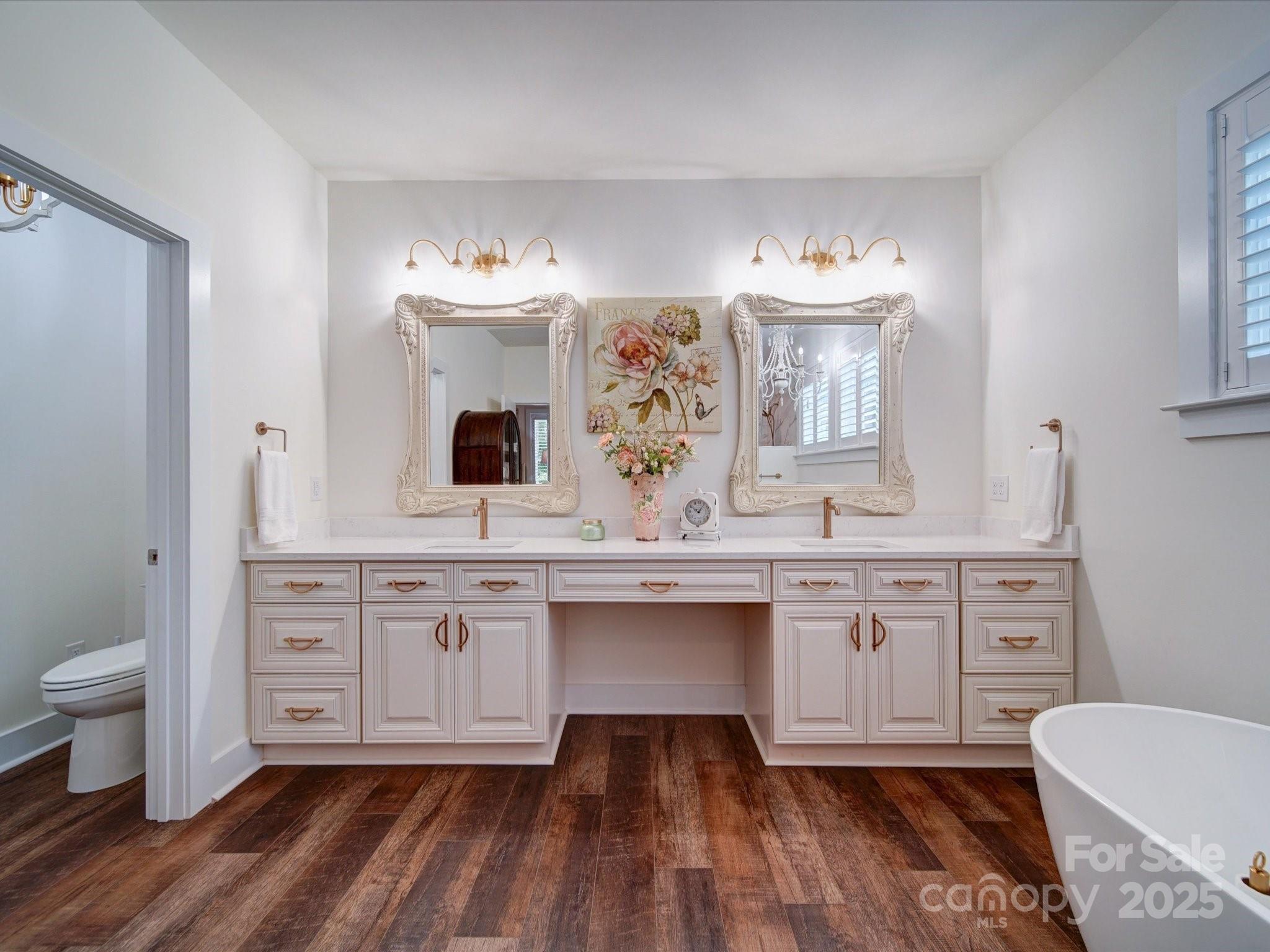 0 Trull Hinson Road, Unit 2 Wingate, NC 28174 - Photo 18 of 25 a spacious bathroom with a double vanity sink a toilet a mirror and shower