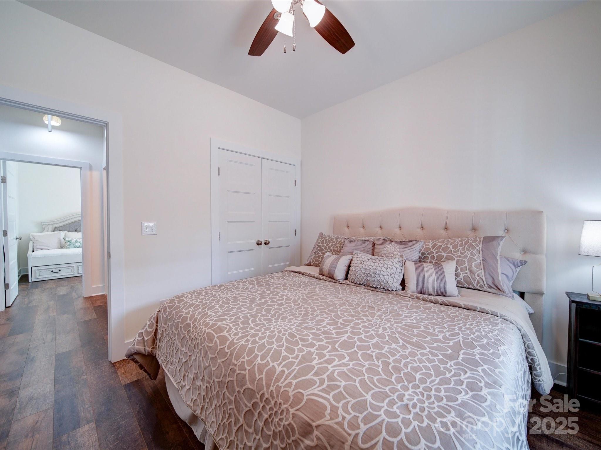 0 Trull Hinson Road, Unit 2 Wingate, NC 28174 - Photo 19 of 25 a bedroom with a large bed and a chandelier