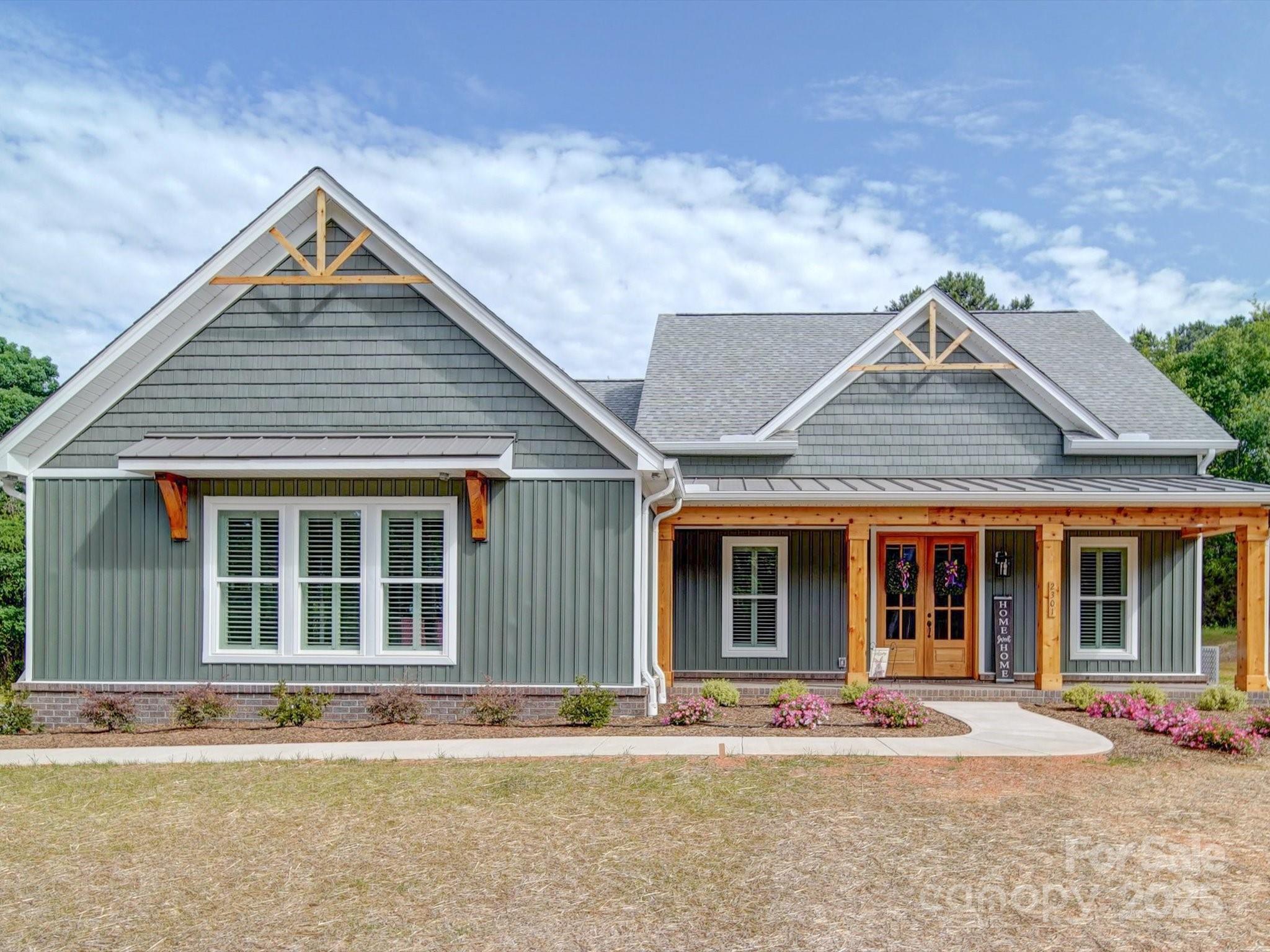 0 Trull Hinson Road, Unit 2 Wingate, NC 28174 - Photo 25 of 25 a front view of a house with a yard and seating space