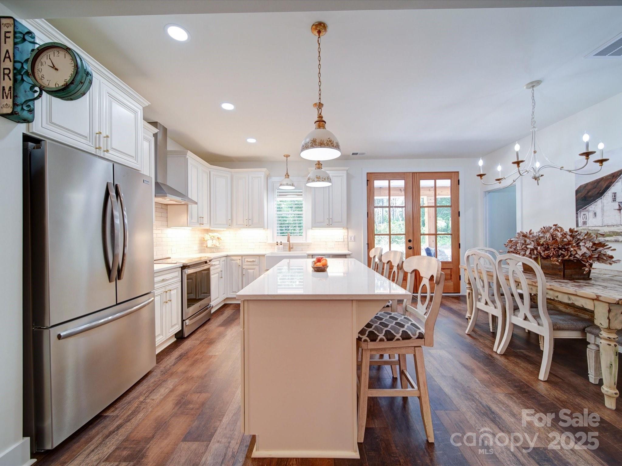 0 Trull Hinson Road, Unit 2 Wingate, NC 28174 - Photo 8 of 25 a kitchen with stainless steel appliances a dining table chairs stove refrigerator and microwave