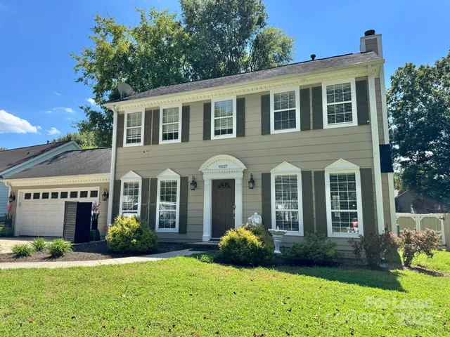 a front view of a house with garden and porch