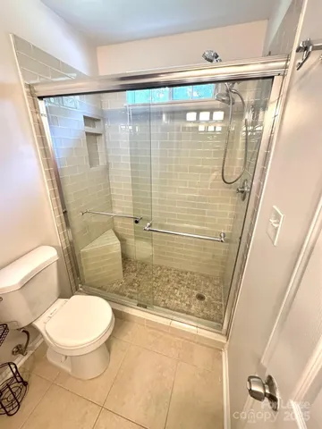 a bathroom with a shower and a toilet