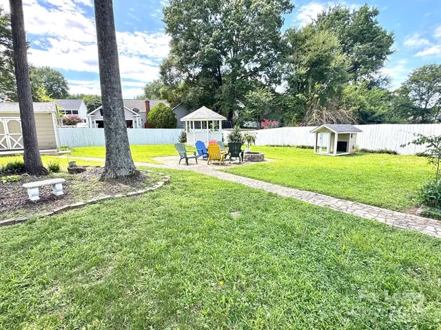 a view of a swimming pool with a garden and lake view