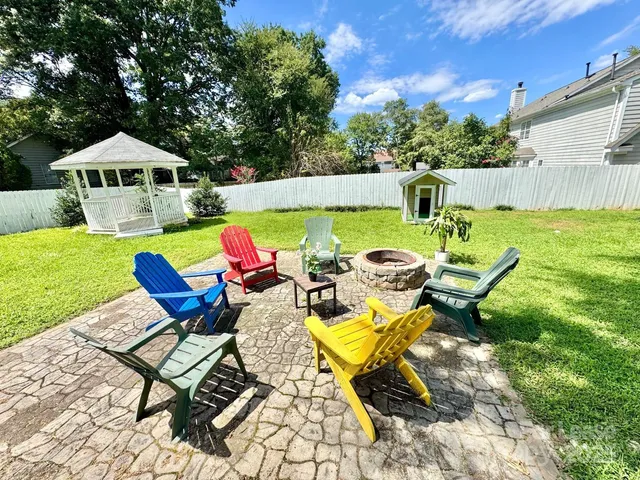 a view of swimming pool with lounge chairs