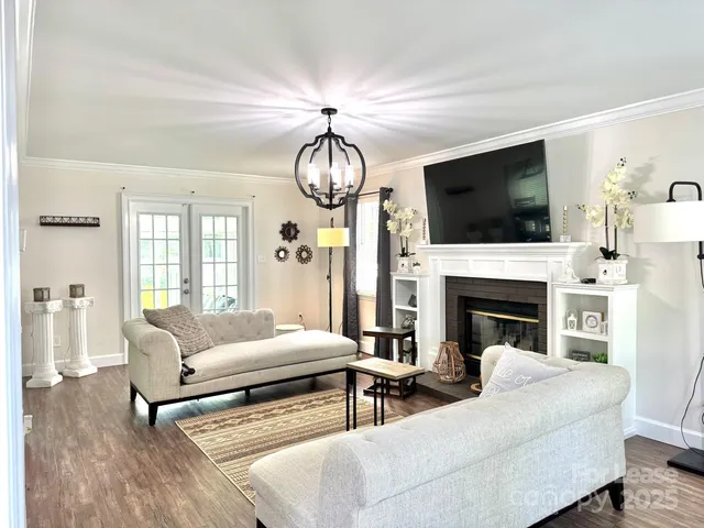 a living room with furniture fireplace and flat screen tv