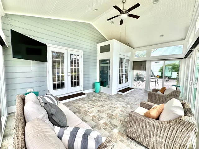 a bedroom with furniture and a large window