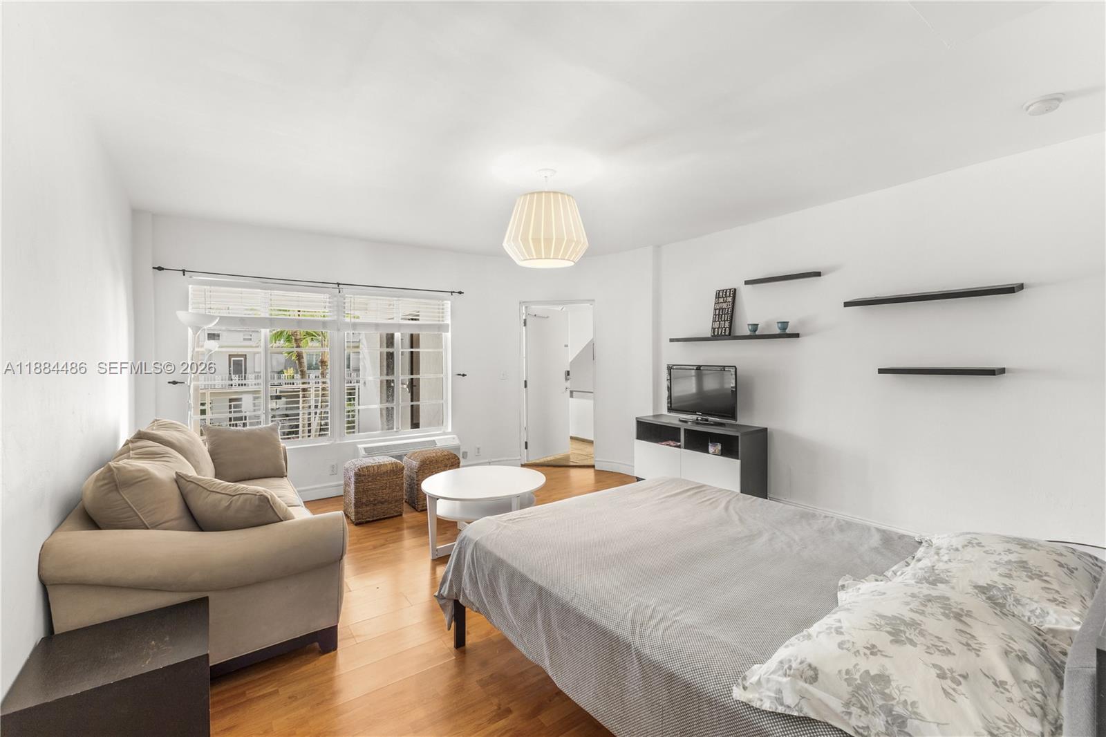 1241 14th Street, Unit 9 Miami Beach, FL 33139 - Photo 12 of 19 a bedroom with furniture and a couch