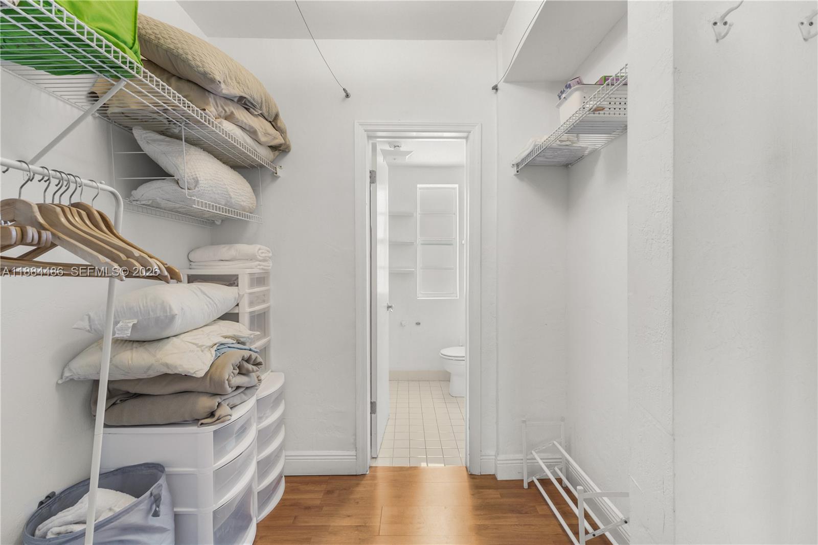 1241 14th Street, Unit 9 Miami Beach, FL 33139 - Photo 16 of 19 a view of walk in closet with clothes and shoes