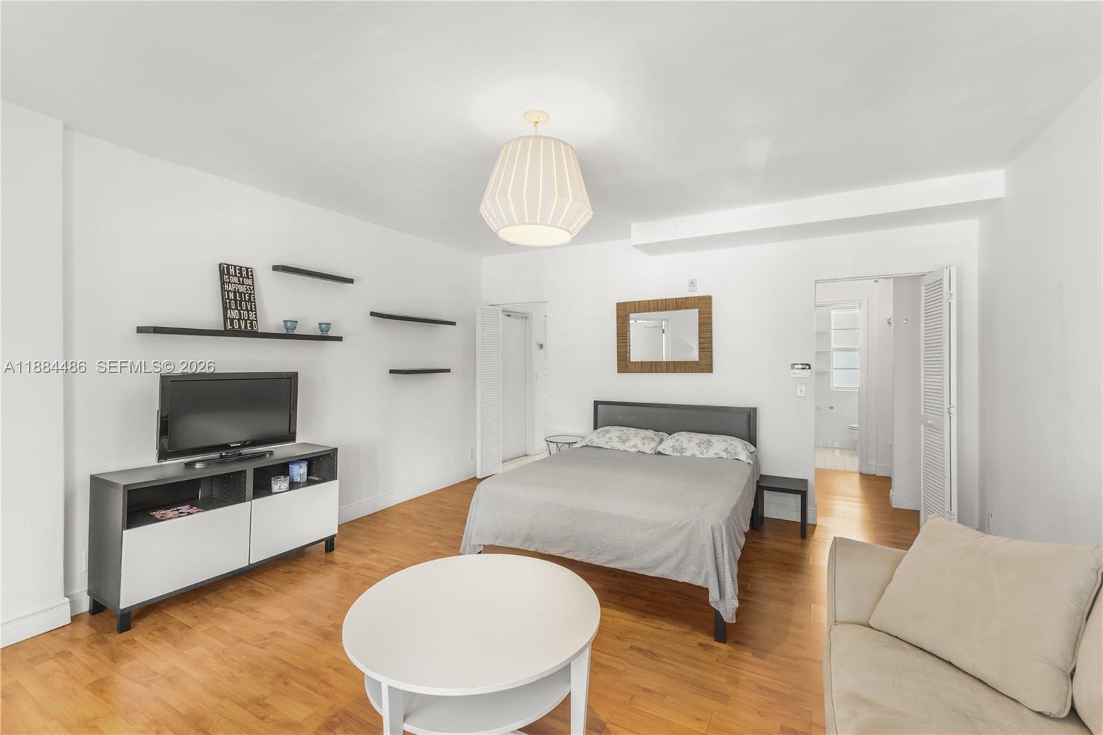 1241 14th Street, Unit 9 Miami Beach, FL 33139 - Photo 9 of 19 a living room with furniture and a flat screen tv