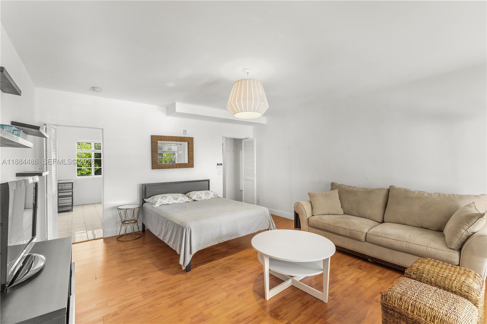 1241 14th Street, Unit 9 Miami Beach, FL 33139 - Photo 10 of 19 a living room with furniture a flat screen tv and a couch