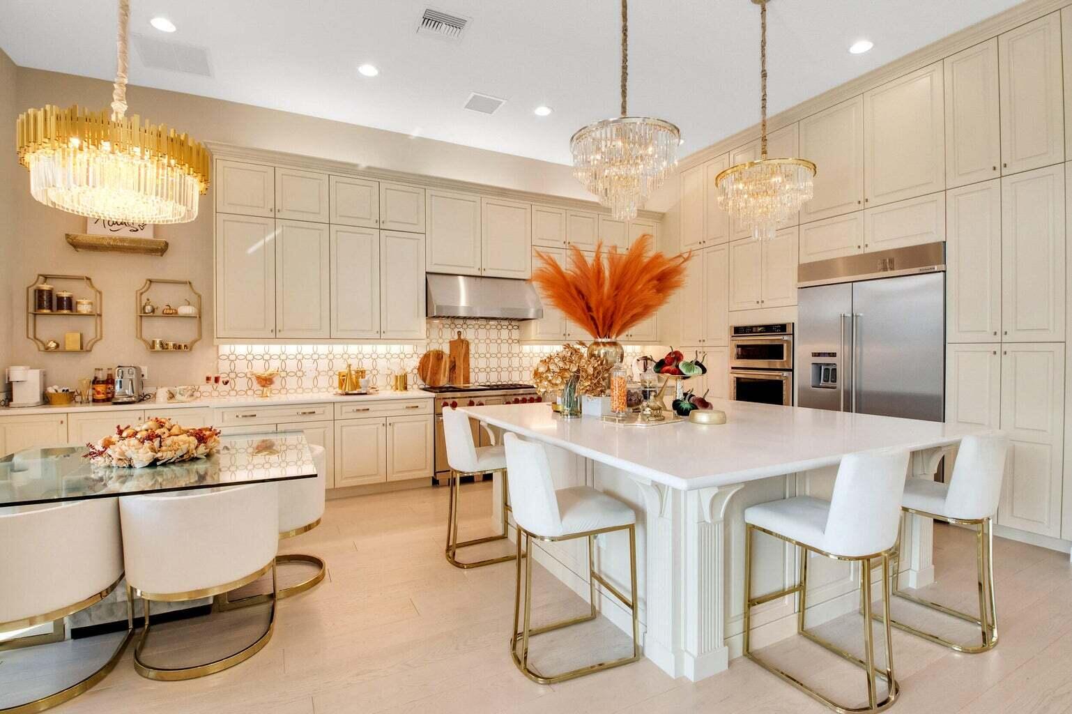 9016 Chauvet Way Boca Raton, FL 33496 - Photo 13 of 79 a kitchen with stainless steel appliances kitchen island granite countertop a table chairs and a refrigerator