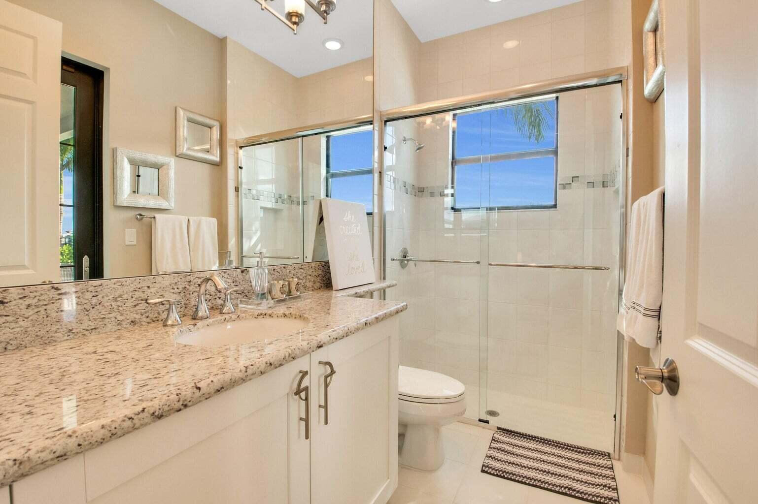 9016 Chauvet Way Boca Raton, FL 33496 - Photo 28 of 79 a bathroom with a granite countertop sink mirror vanity and toilet
