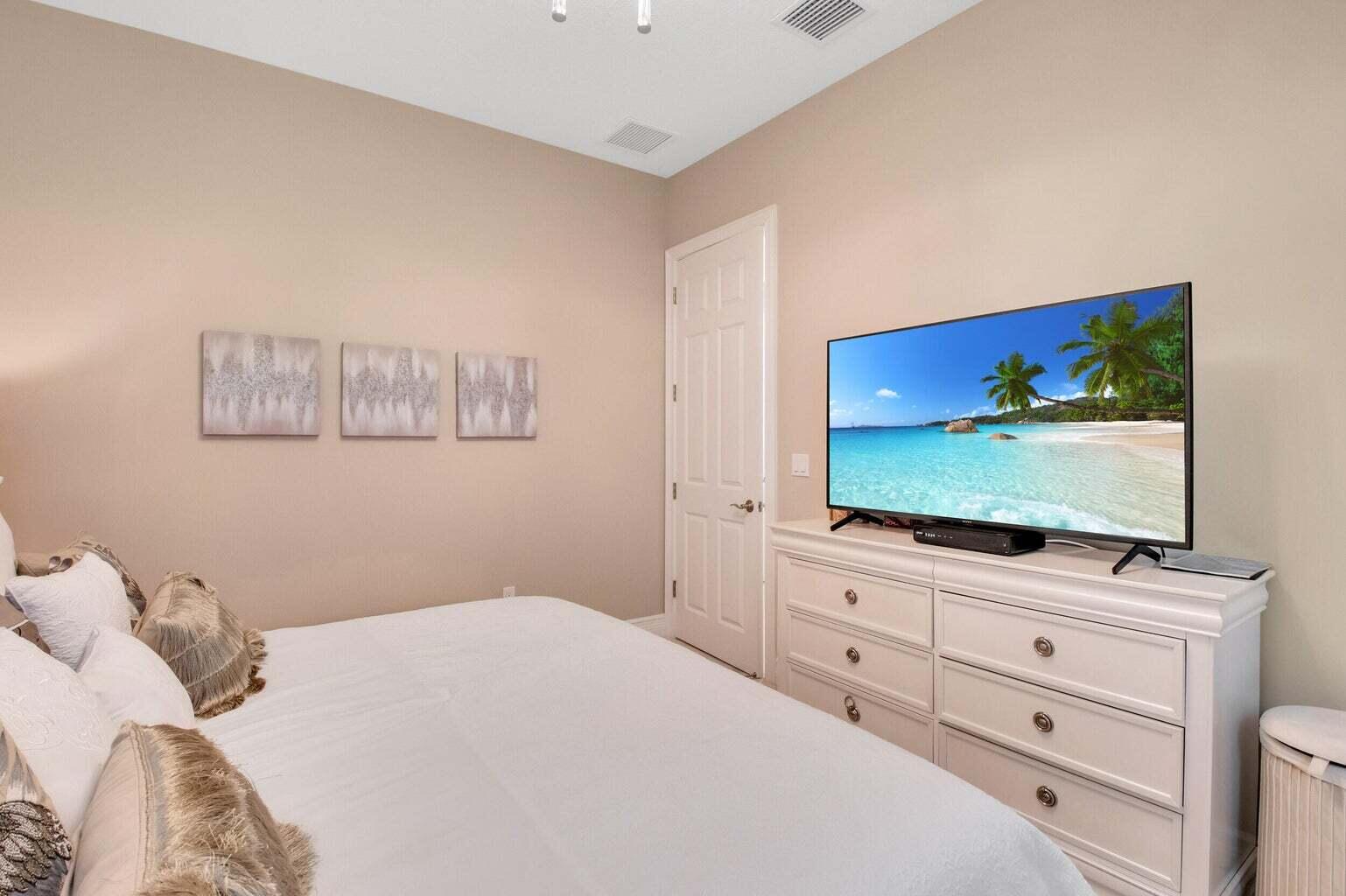 9016 Chauvet Way Boca Raton, FL 33496 - Photo 33 of 79 a bedroom with a bed and a flat screen tv