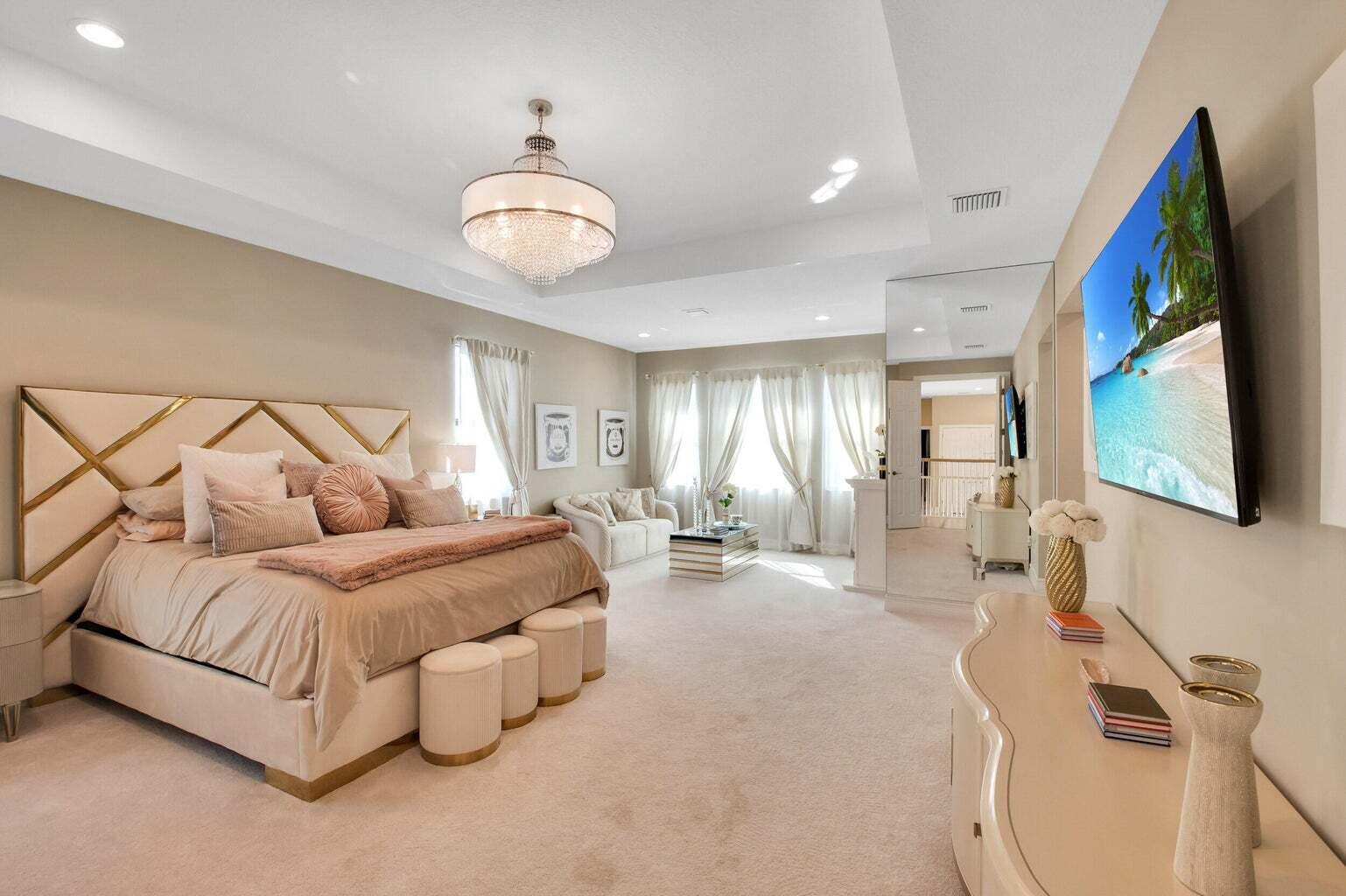 9016 Chauvet Way Boca Raton, FL 33496 - Photo 40 of 79 a spacious bedroom with a bed couch chandelier and a flat tv screen