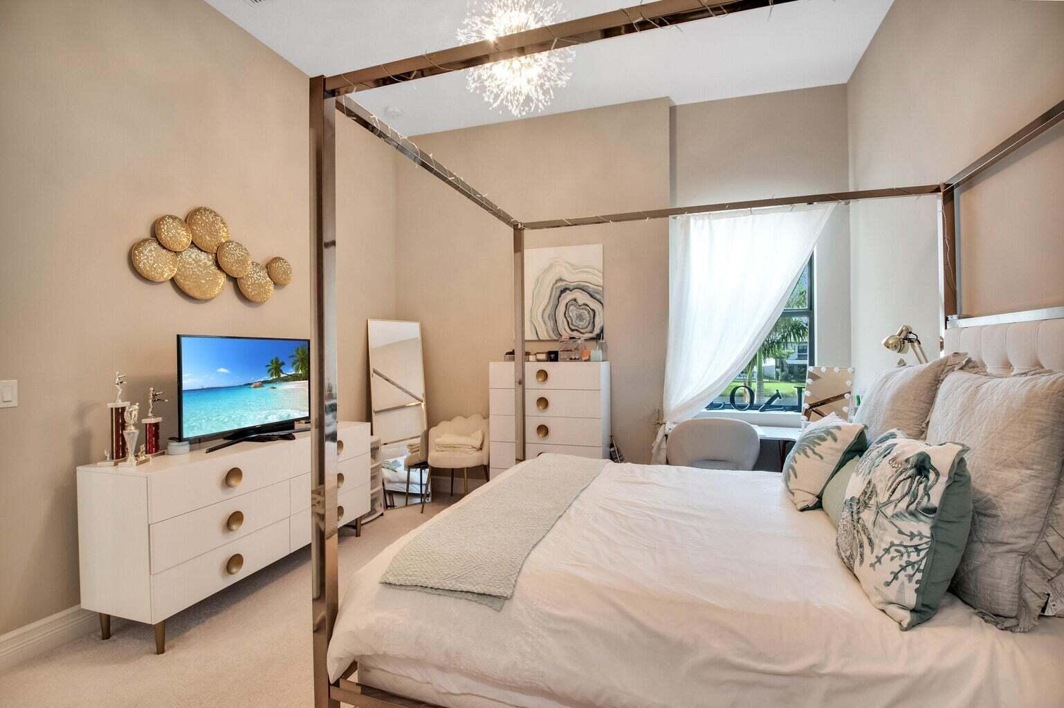 9016 Chauvet Way Boca Raton, FL 33496 - Photo 50 of 79 a bedroom with a bed and a flat tv screen on dresser