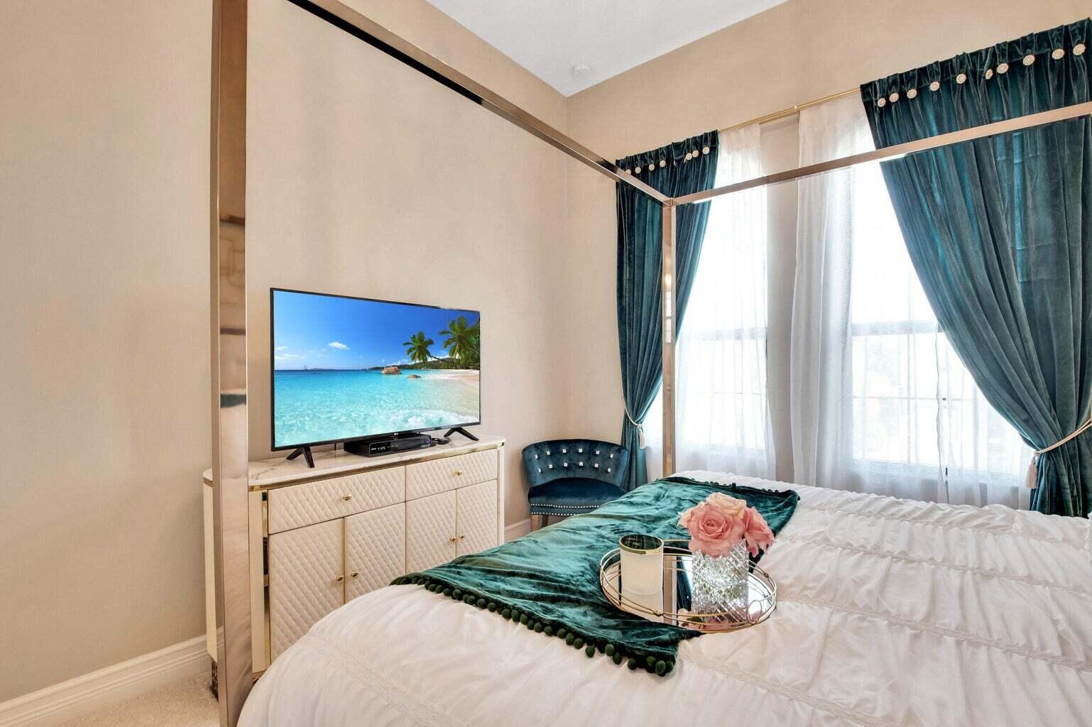9016 Chauvet Way Boca Raton, FL 33496 - Photo 59 of 79 a bedroom with a bed and a flat screen tv