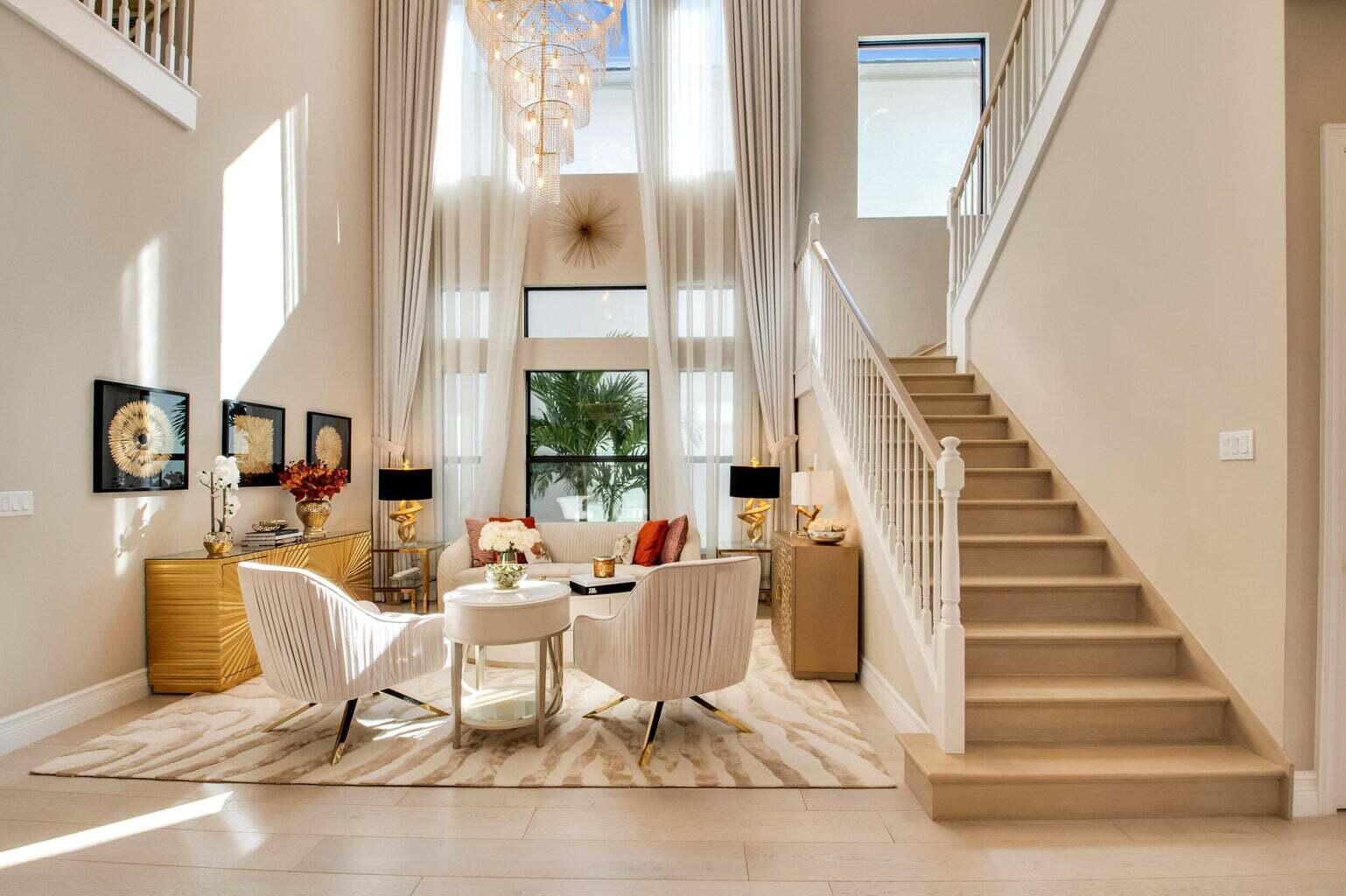 9016 Chauvet Way Boca Raton, FL 33496 - Photo 6 of 79 a view of a living room with a floor to ceiling window and stairs