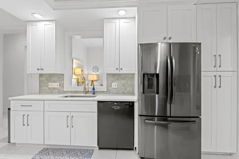 a kitchen with stainless steel appliances white cabinets and a sink