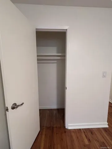 a view of walk in closet with wooden floor
