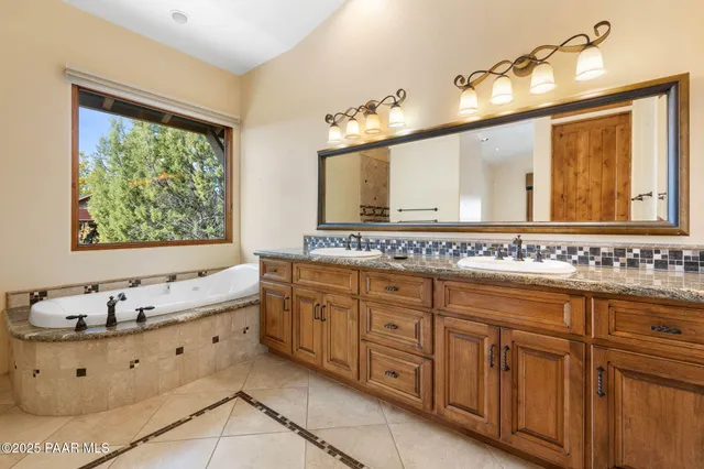 a bathroom with a tub sink and mirror