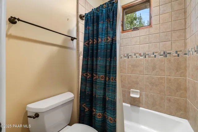 a bathroom with a toilet and shower