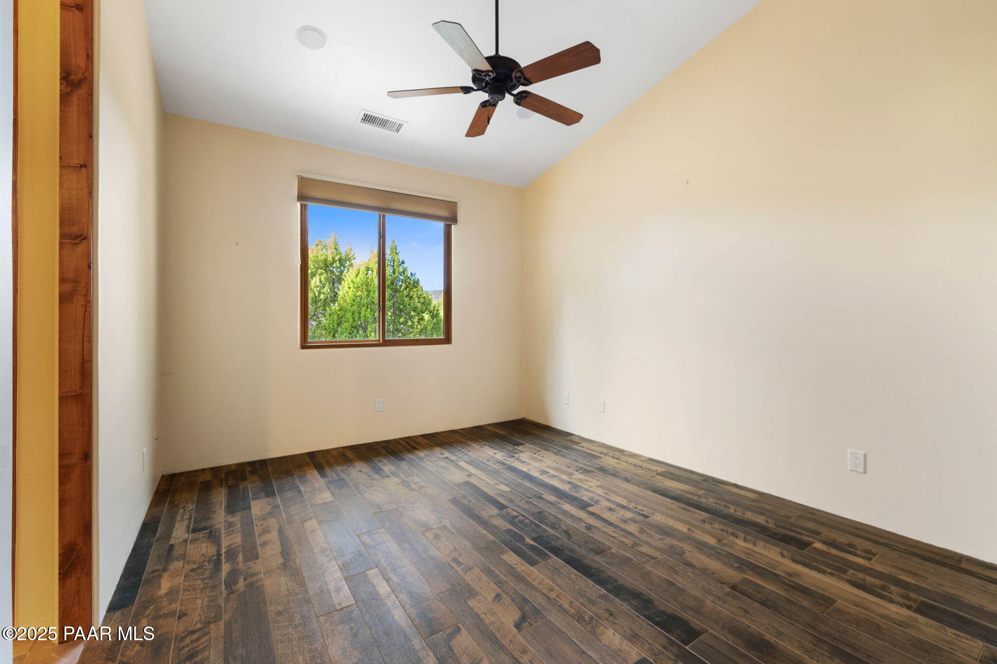 14850 Jay Morrish Drive Prescott, AZ 86305 - Photo 17 of 49 an empty room with wooden floor ceiling fan and windows