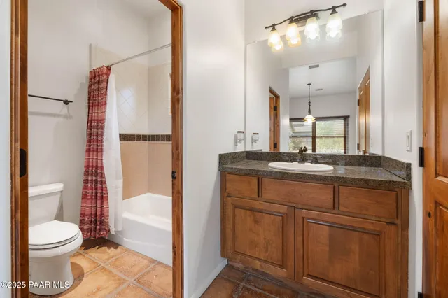 a bathroom with a toilet a sink and a mirror