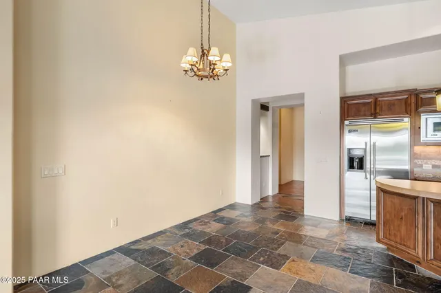 a view of a kitchen with a sink and a chandelier