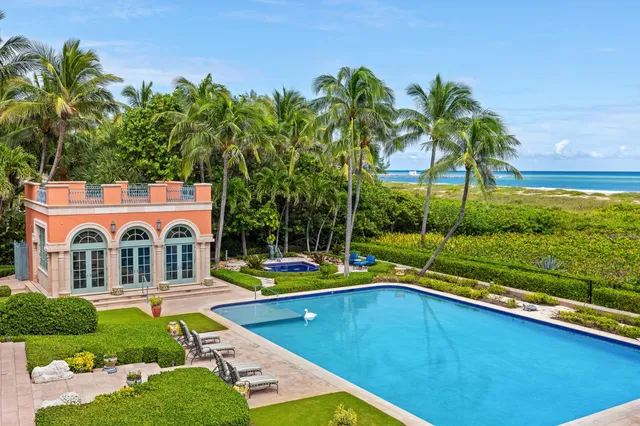 a living room with fireplace furniture and a large window