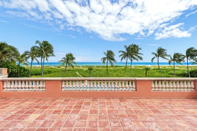 a front view of a house with swimming pool having outdoor seating