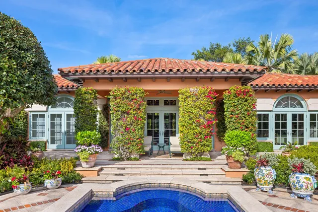 a view of an outdoor dining space with a table and chairs