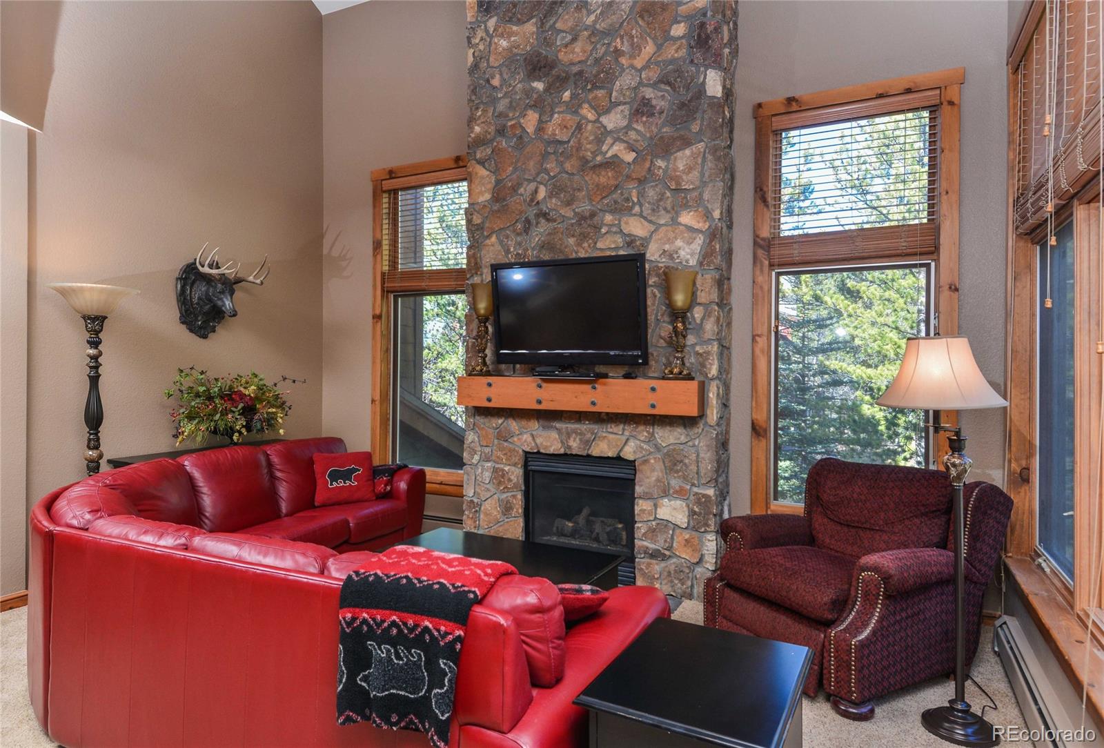 57 Lake Ridge Circle Keystone, CO 80435 - Photo 3 of 27 a living room with furniture a flat screen tv and a fireplace