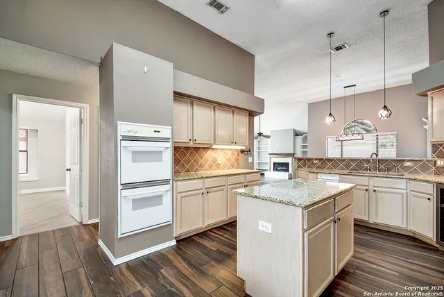 a kitchen with stainless steel appliances granite countertop a sink and cabinets