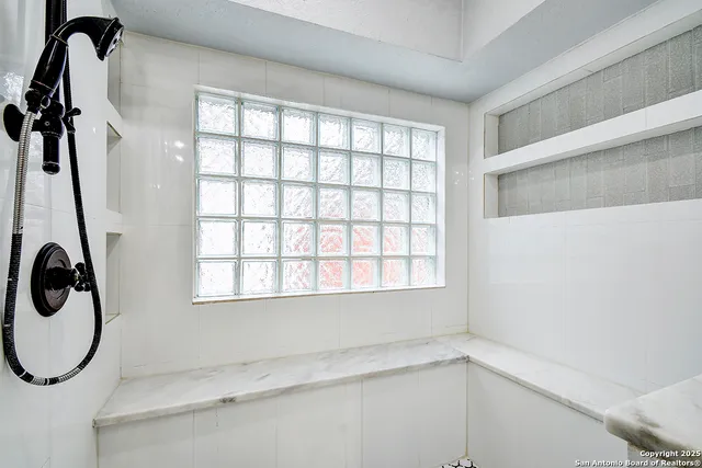 a bathroom with a bathtub and a window
