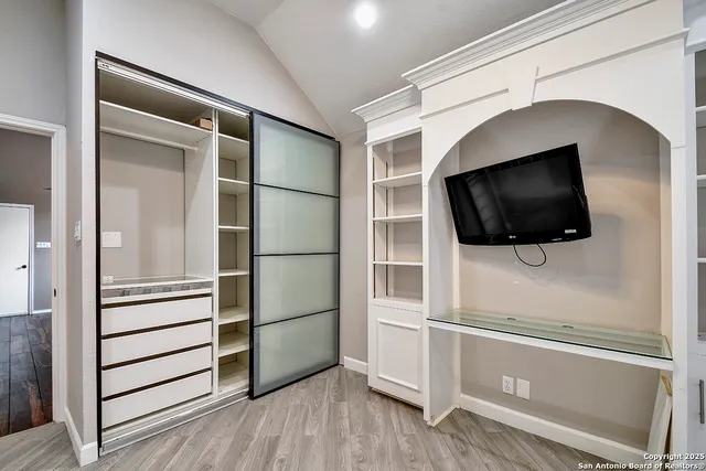 a view of a livingroom with an empty space and wooden floor