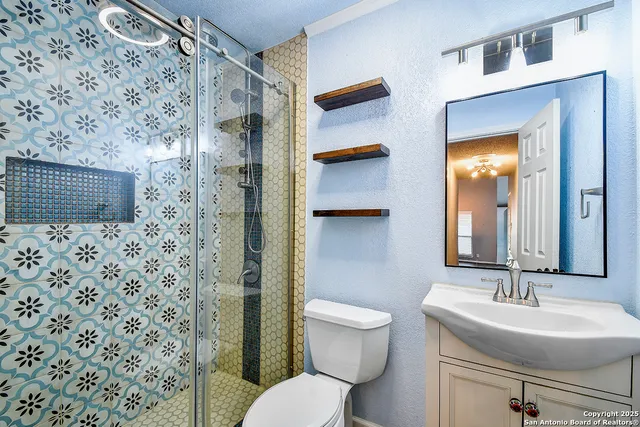 a bathroom with a sink toilet and shower