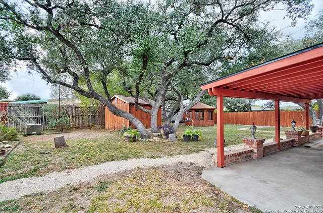 a backyard of a house with trampoline fire pit tables and chairs