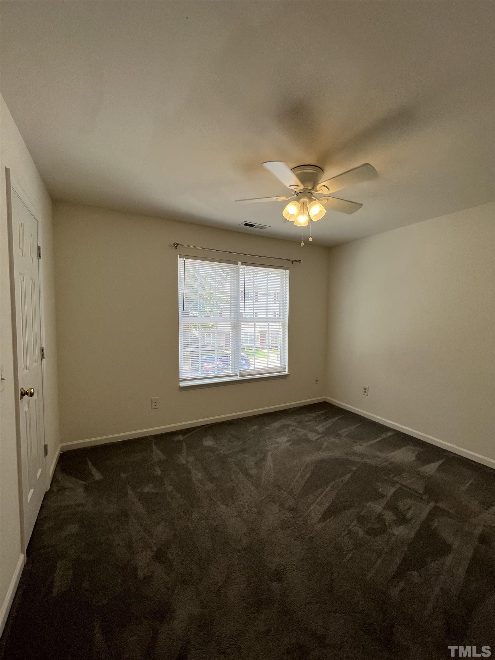 23 Red Lane Raleigh, NC 27606 - Photo 13 of 13 an empty room with a ceiling fan and window