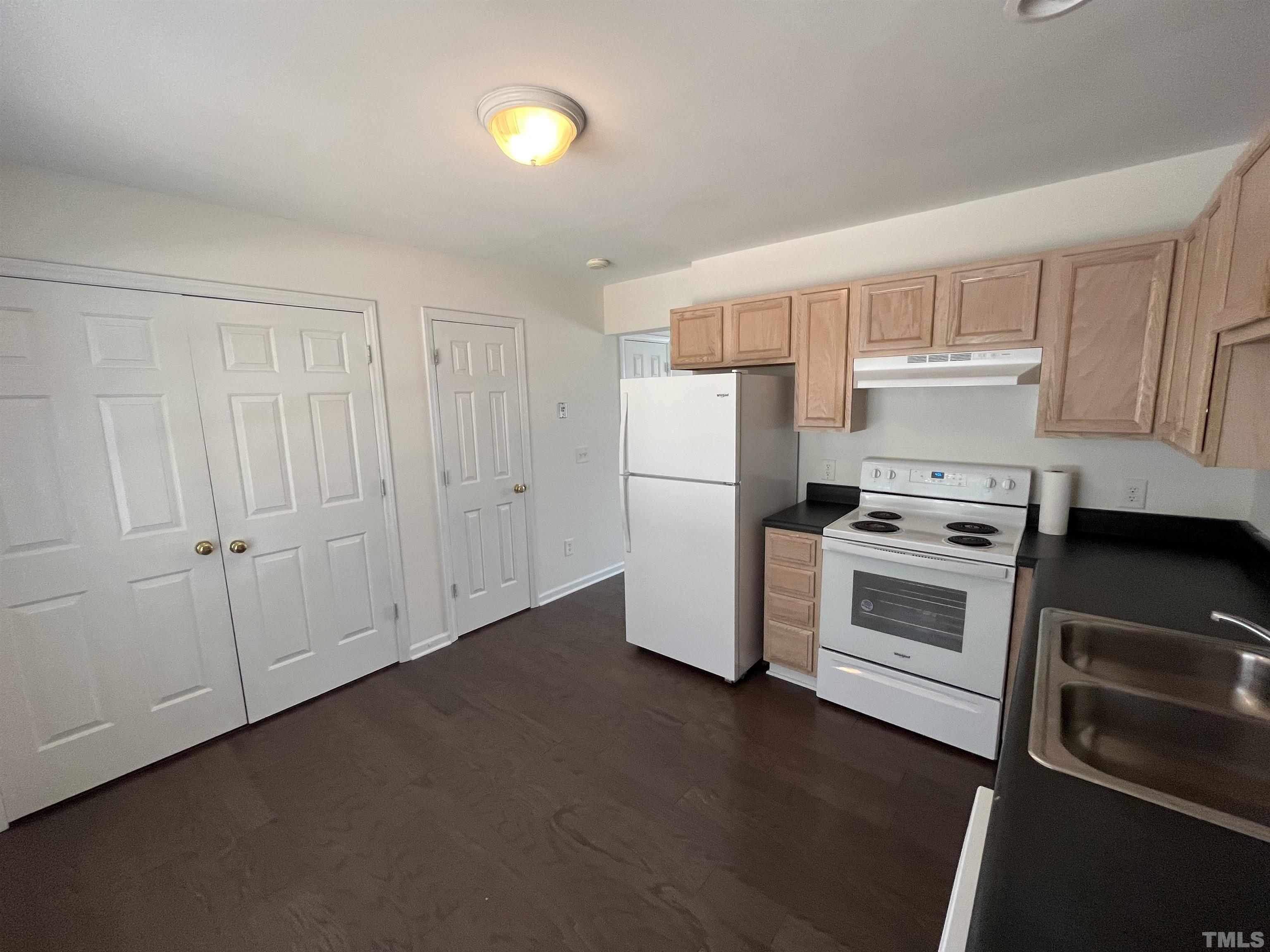 23 Red Lane Raleigh, NC 27606 - Photo 3 of 13 a kitchen with a refrigerator stove and white cabinets