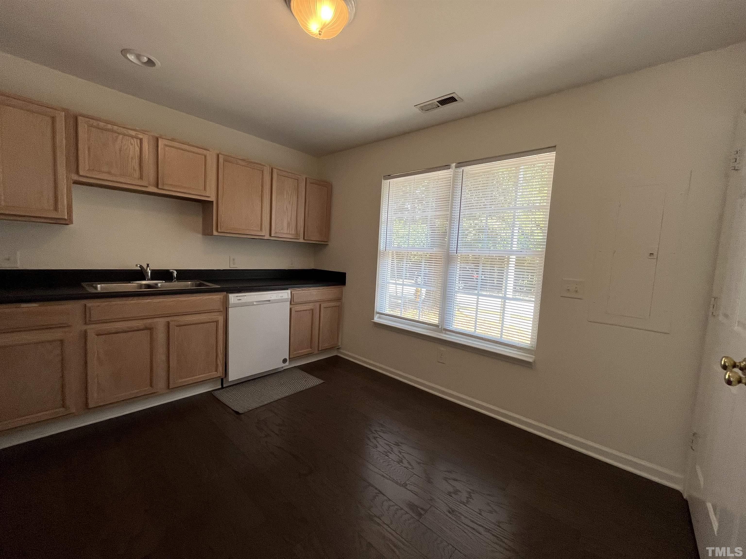23 Red Lane Raleigh, NC 27606 - Photo 5 of 13 a kitchen with a sink a window and cabinets