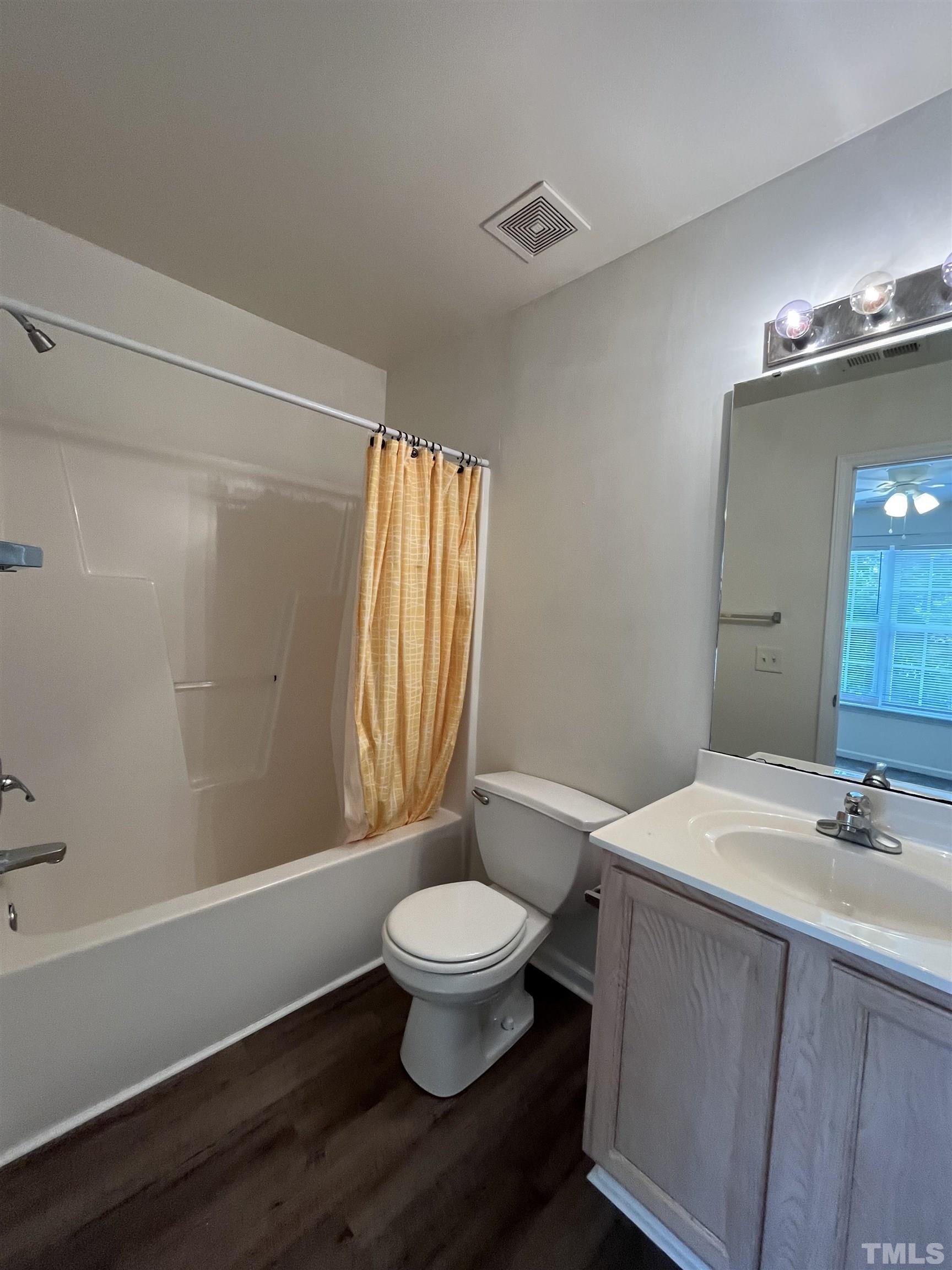 23 Red Lane Raleigh, NC 27606 - Photo 10 of 13 a bathroom with a sink a toilet a mirror and shower