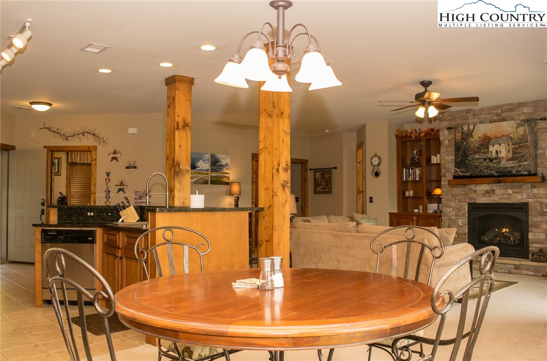 114 Red Deer Road, Unit D Banner Elk, NC 28604 - Photo 12 of 40 a dining room with furniture a chandelier and fireplace