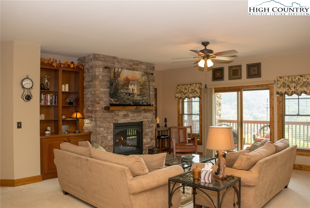 114 Red Deer Road, Unit D Banner Elk, NC 28604 - Photo 13 of 40 a living room with furniture a fireplace and a flat screen tv