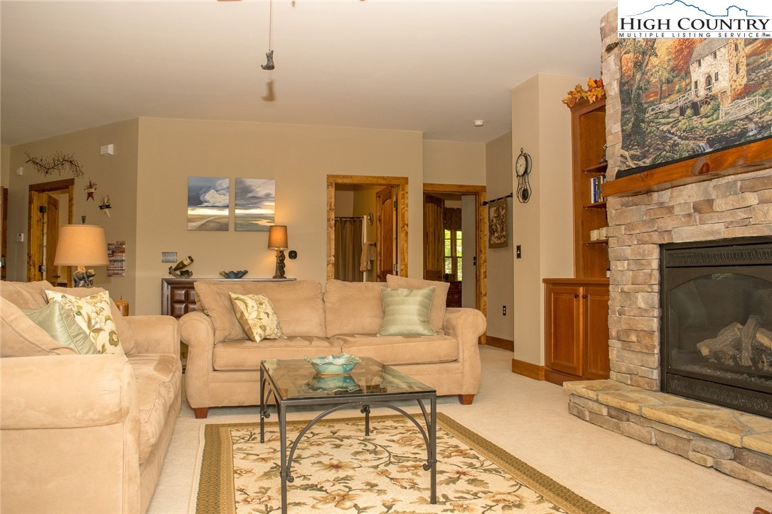 114 Red Deer Road, Unit D Banner Elk, NC 28604 - Photo 15 of 40 a living room with furniture a fireplace and a table