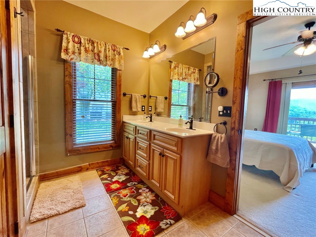 114 Red Deer Road, Unit D Banner Elk, NC 28604 - Photo 26 of 40 a bathroom with a sink a mirror and a bathtub
