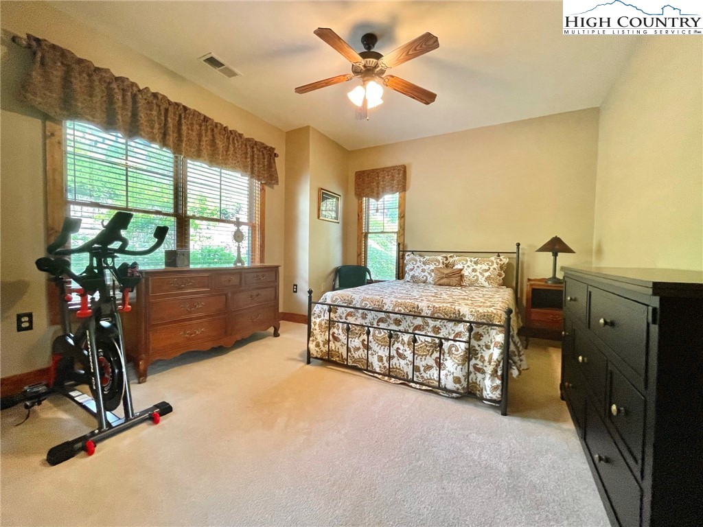 114 Red Deer Road, Unit D Banner Elk, NC 28604 - Photo 27 of 40 a bedroom with a bed dresser and a windows