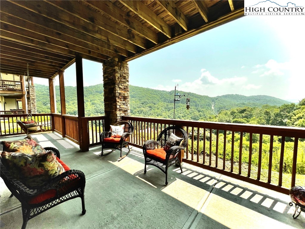 114 Red Deer Road, Unit D Banner Elk, NC 28604 - Photo 4 of 40 a balcony with furniture and wooden floor